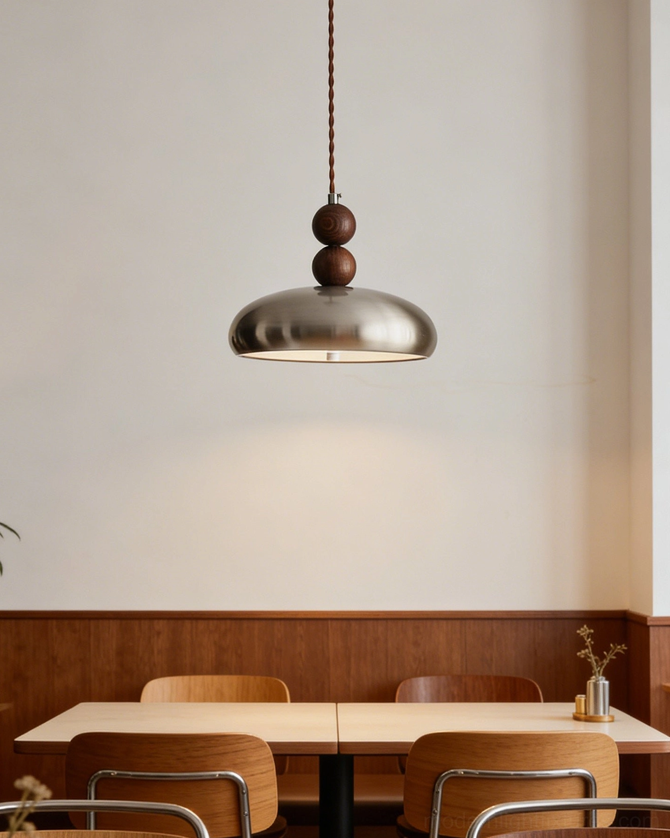 Rellin mid-century modern pendant hanging in restaurant booth with warm wooden paneling and cafe dining ambiance