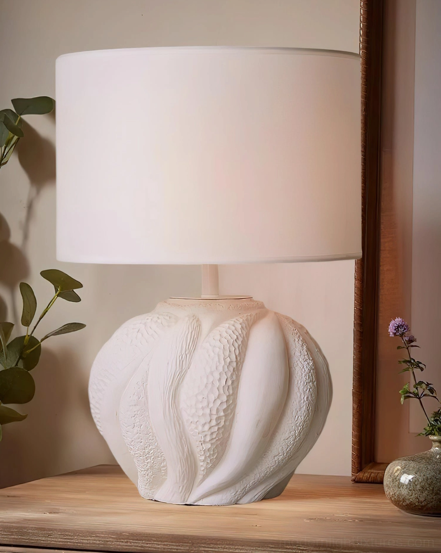 Remi sculptural ceramic lamp paired with wooden console table, potted plants and bohemian home decor