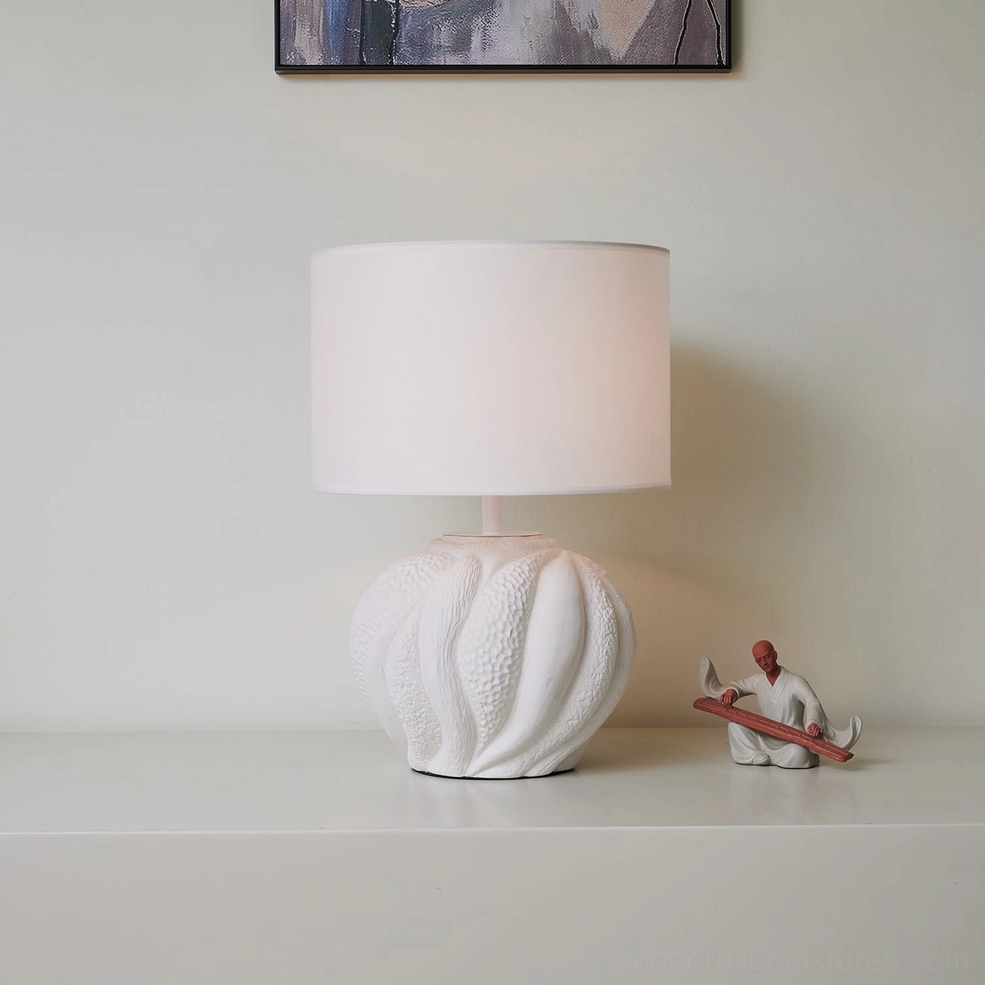 Remi table lamp with decorative figurine accent in simple modern home interior arrangement