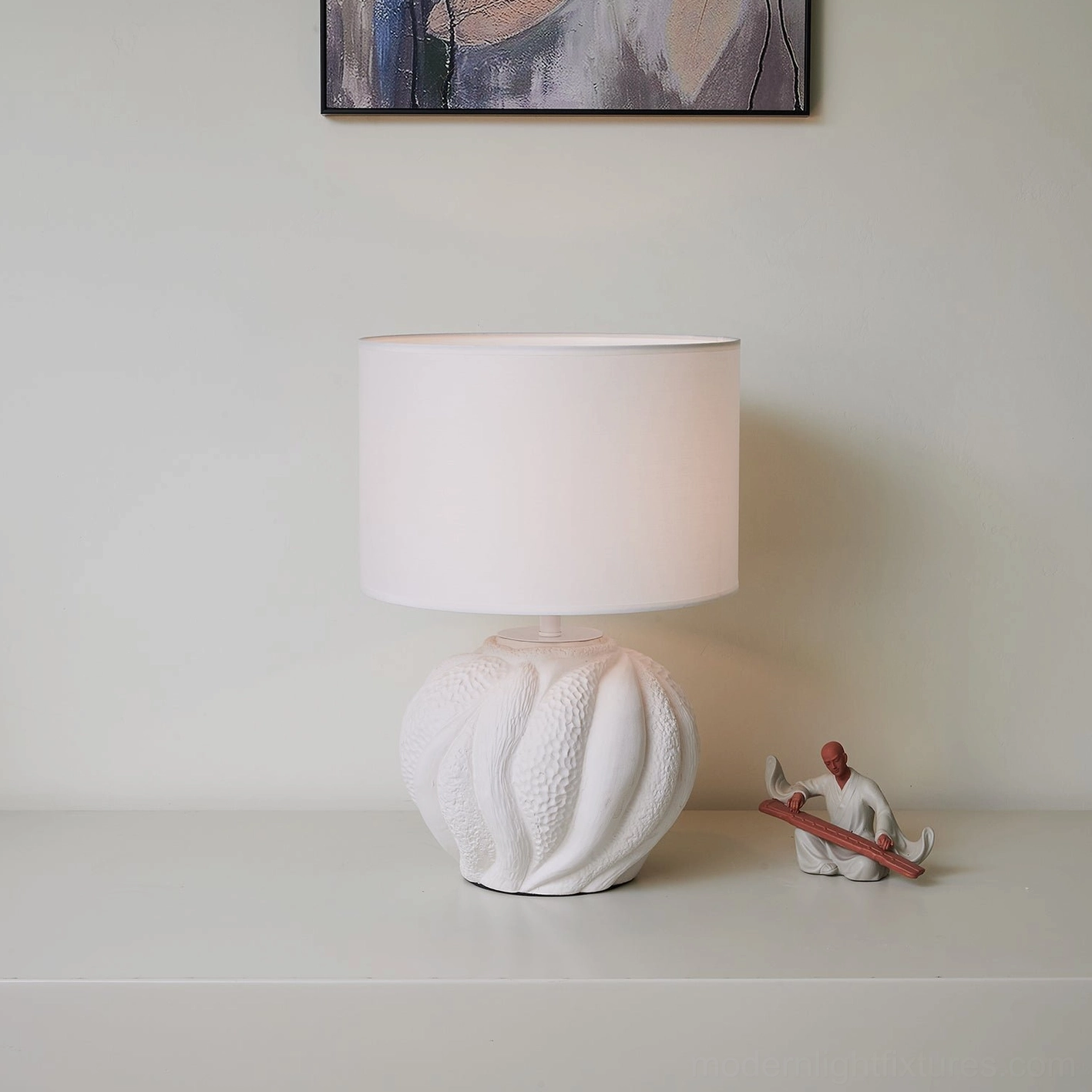 Modern Remi table lamp in home interior setting on side table with decorative accessories and wall art