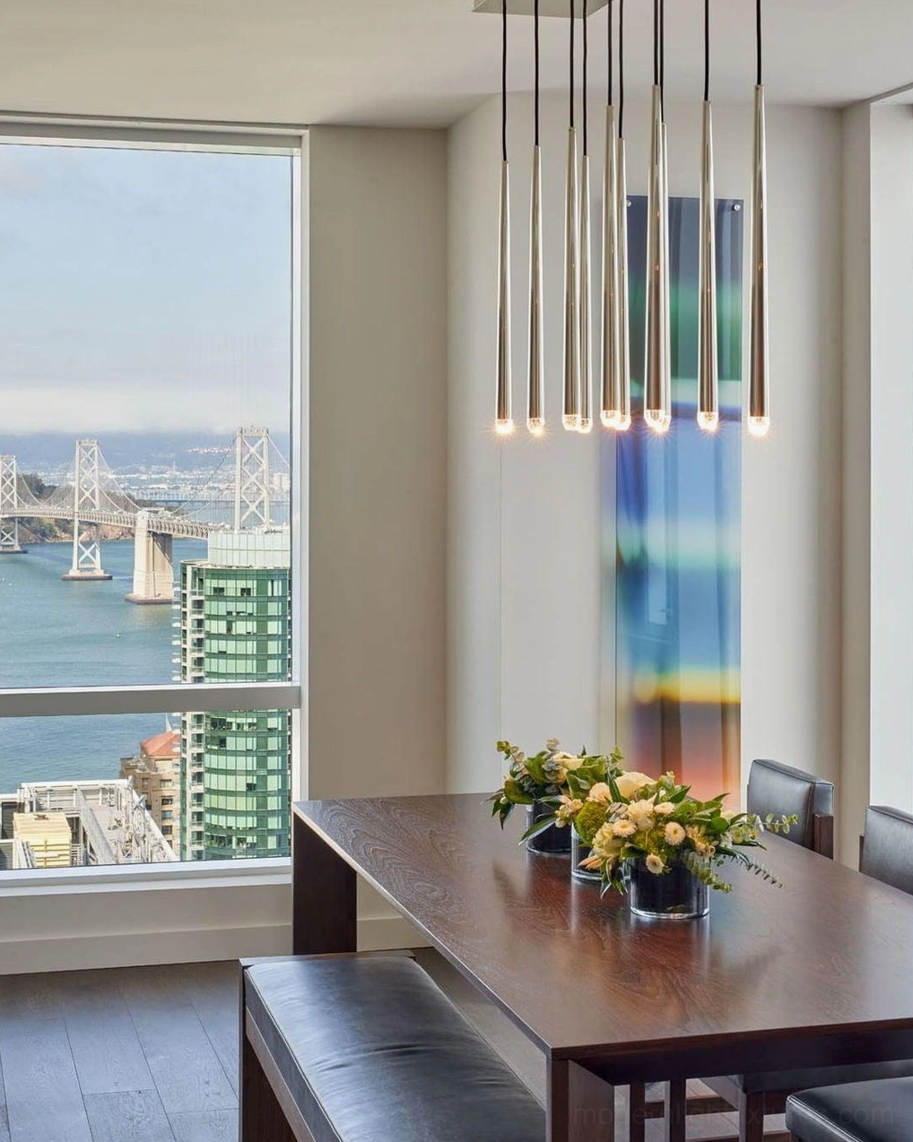 Renaie Brass Cluster Chandelier in high-rise apartment dining space with metallic finish linear hanging