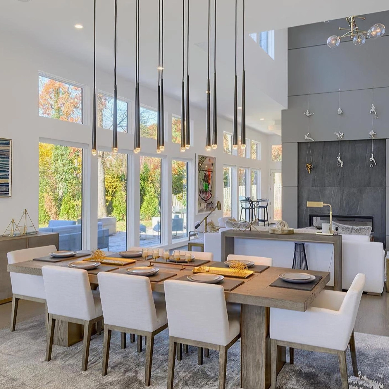 Renaie Modern Chandelier in open dining kitchen with light wood furniture and tapered metal rods