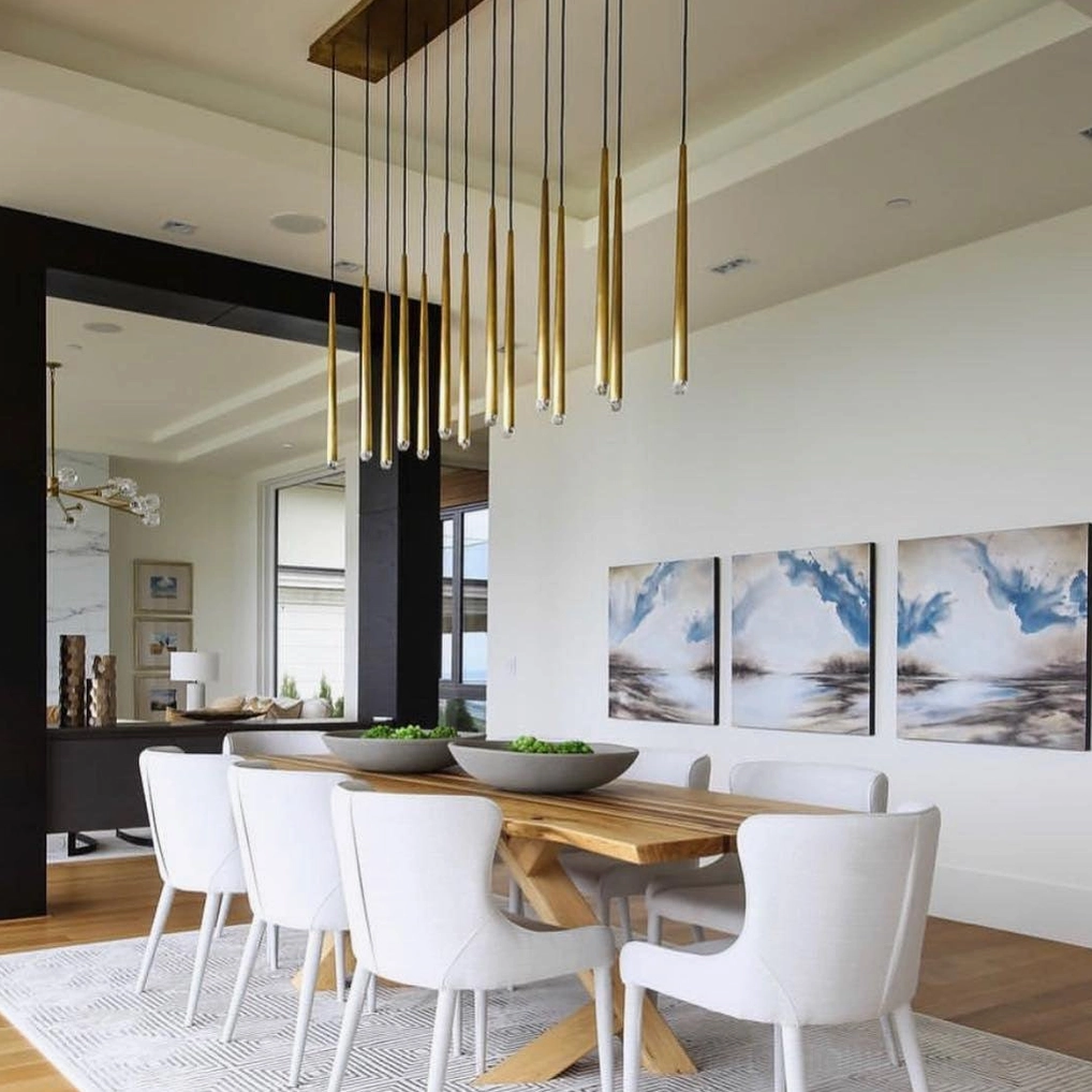 Renaie Modern Chandelier in open concept luxury dining space with brass gold tapered pendants
