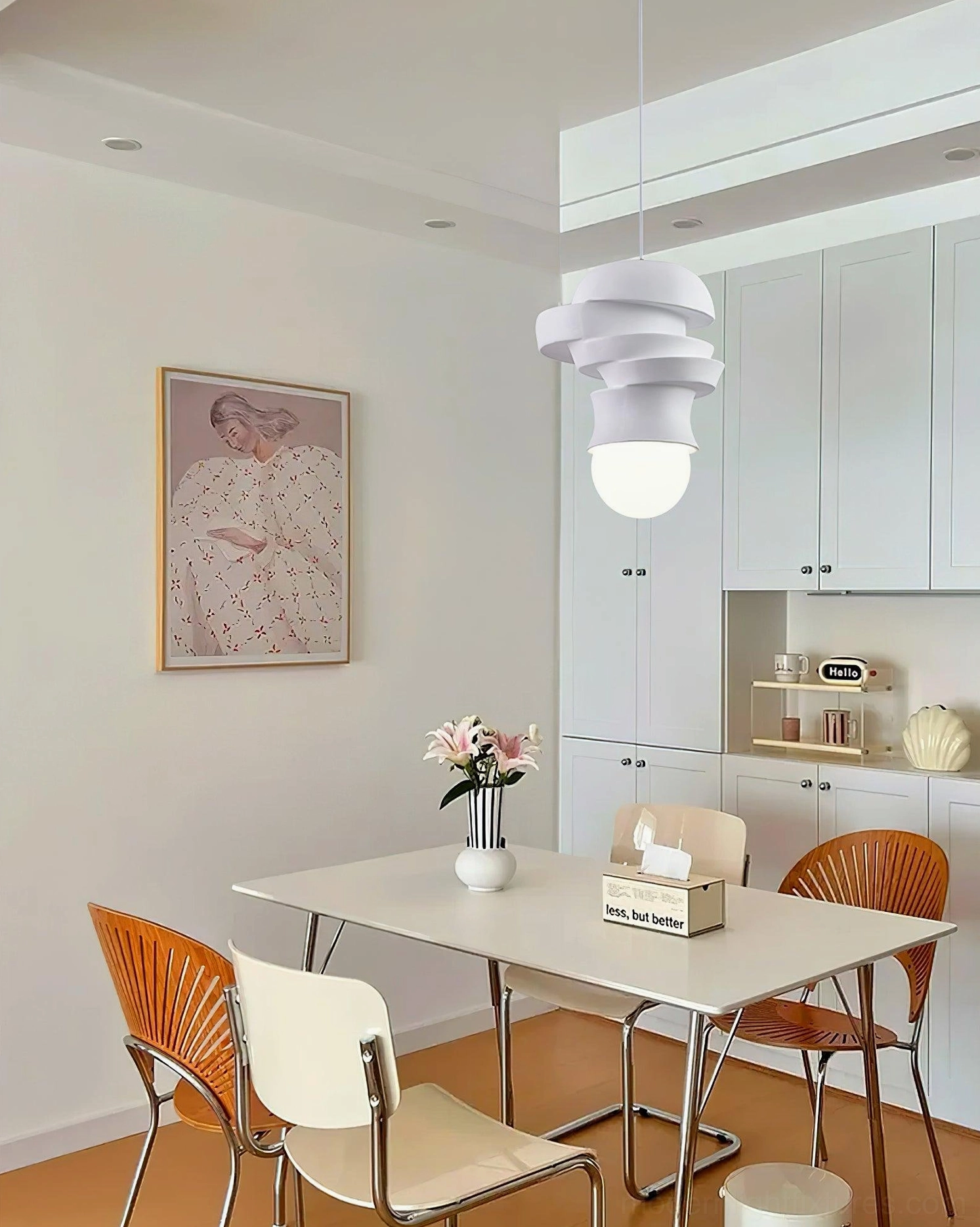 Modern white layered pendant light fixture suspended in warm residential dining room, contemporary home decor installation