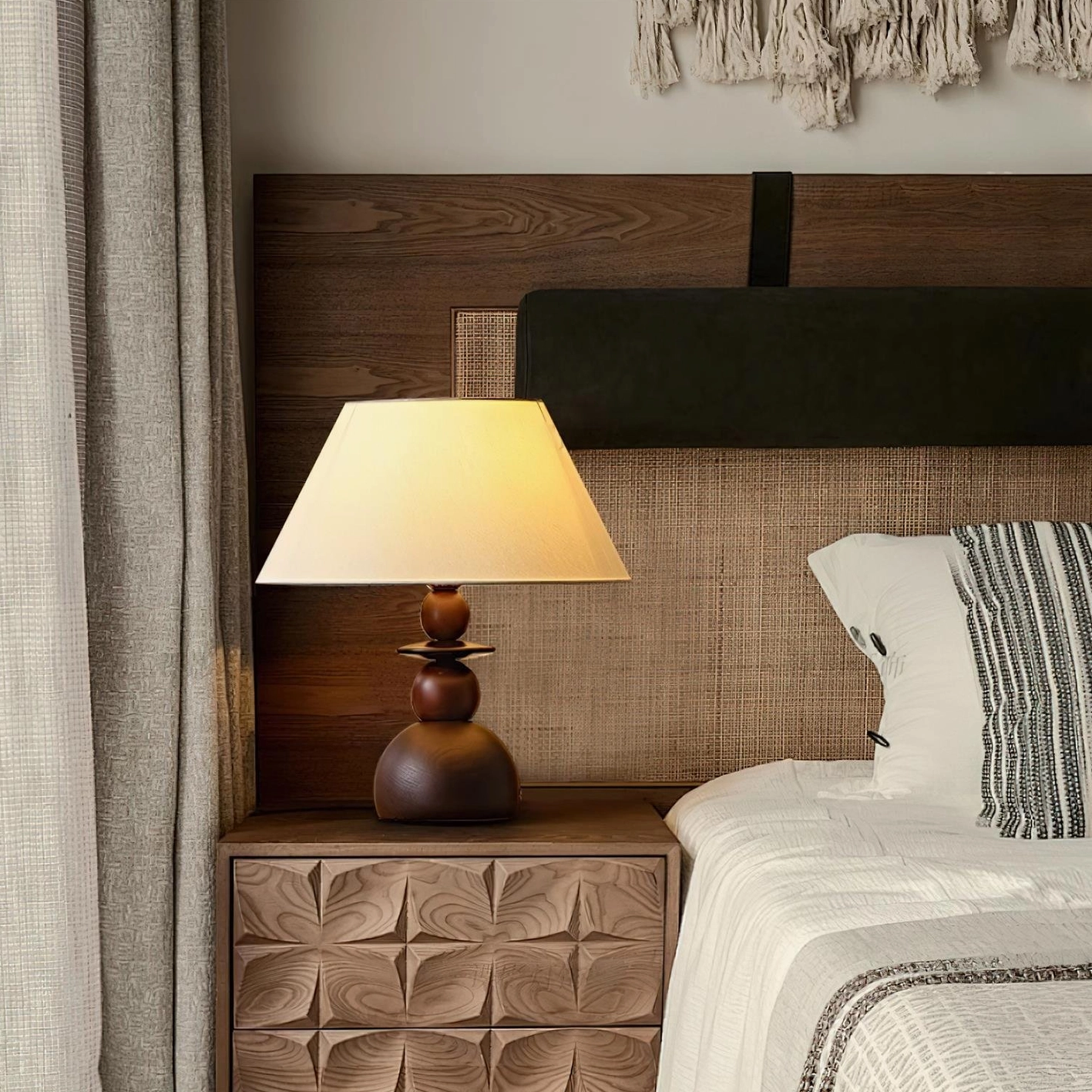 Walnut stacked wood table lamp with cream colored fabric shade in residential interior setting