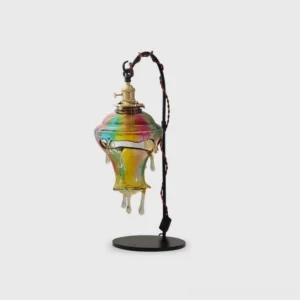 Modern resin drip glass table lamp with twisted black metal stand, front studio view showcasing clear sculptural shade