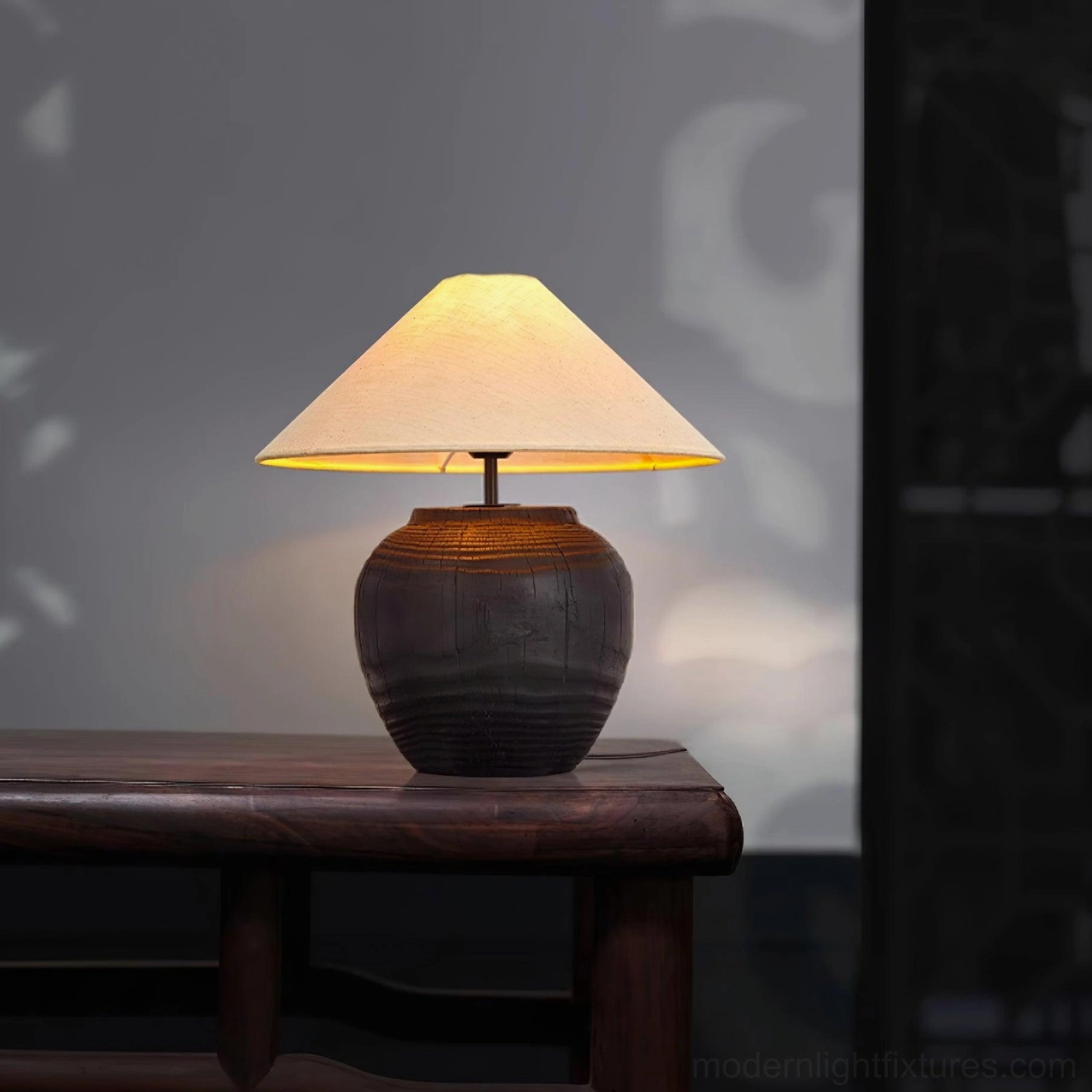 Black resin table lamp with fabric shade studio product shot with soft lighting