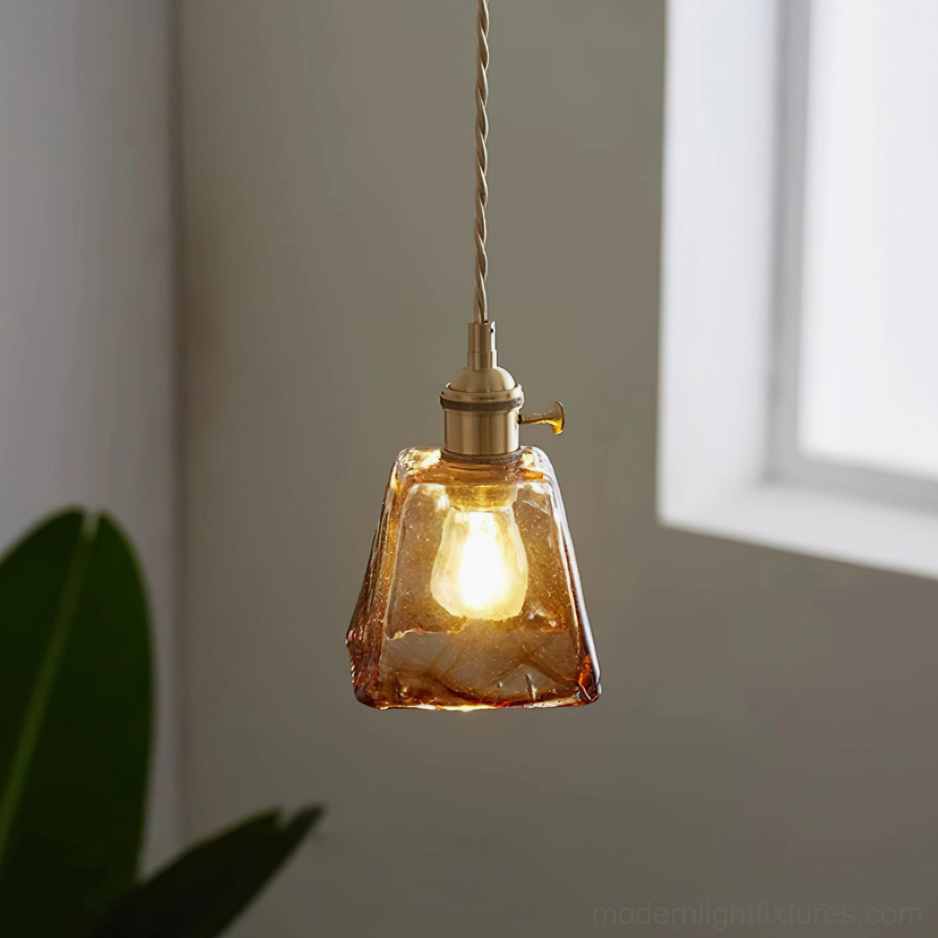Retro amber glass pendant light with brass components - side angle view