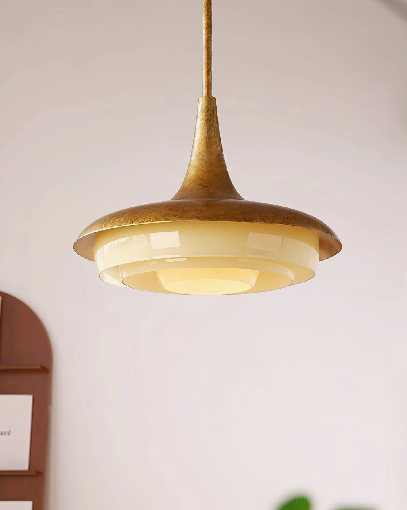 Retro brass pendant lamp with layered frosted glass, front three-quarter decorative placement view