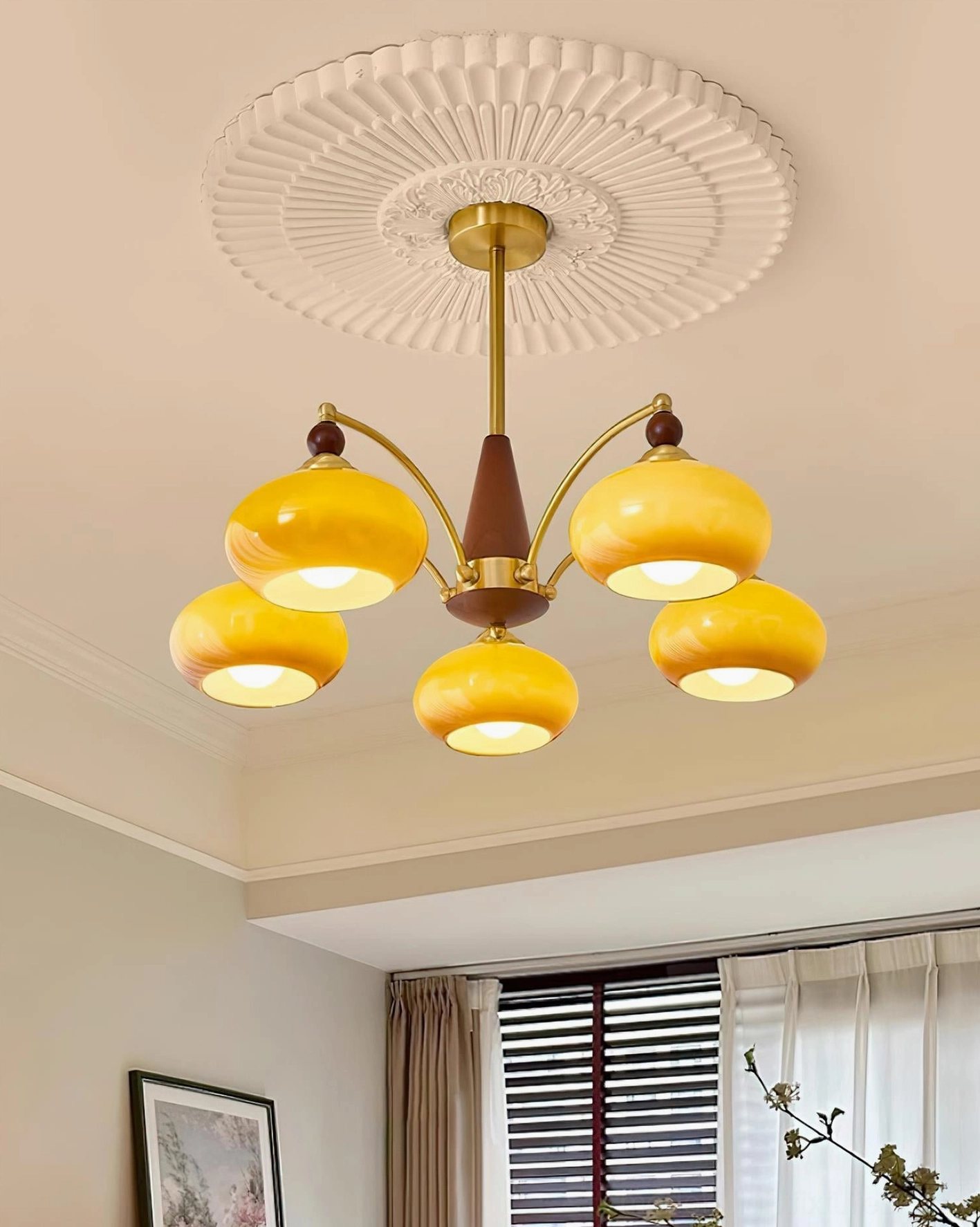Retro Calliope 5-head pendant light installed in residential living room with green sofa and contemporary decor - warm ambient lighting effect