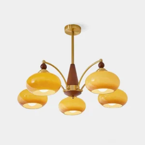 Retro Calliope 5-light chandelier with brass metal frame, wood accents, and warm caramel glass shades on white background - mid-century modern style pendant