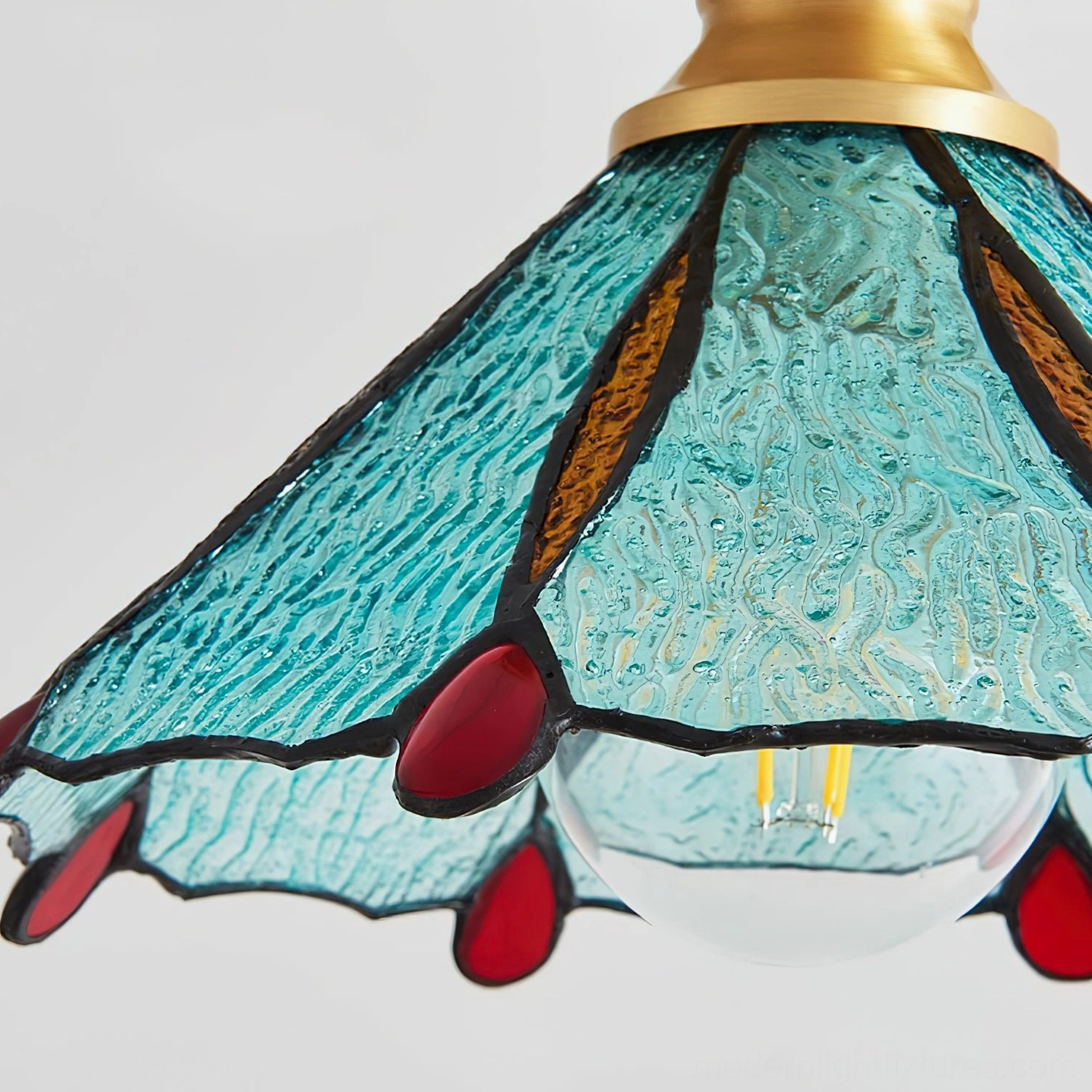 Retro stained glass ceiling light detail showing brass canopy and glass arrangement