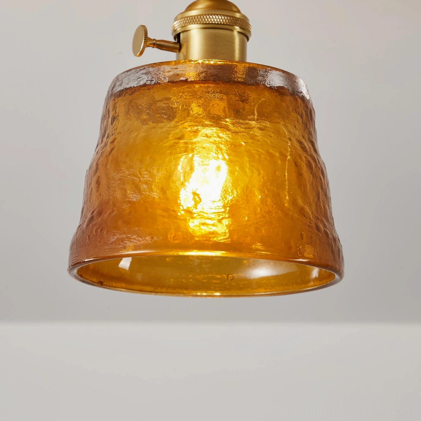 Retro ceiling light fixture detail showing wood canopy brass hardware hand-blown glass