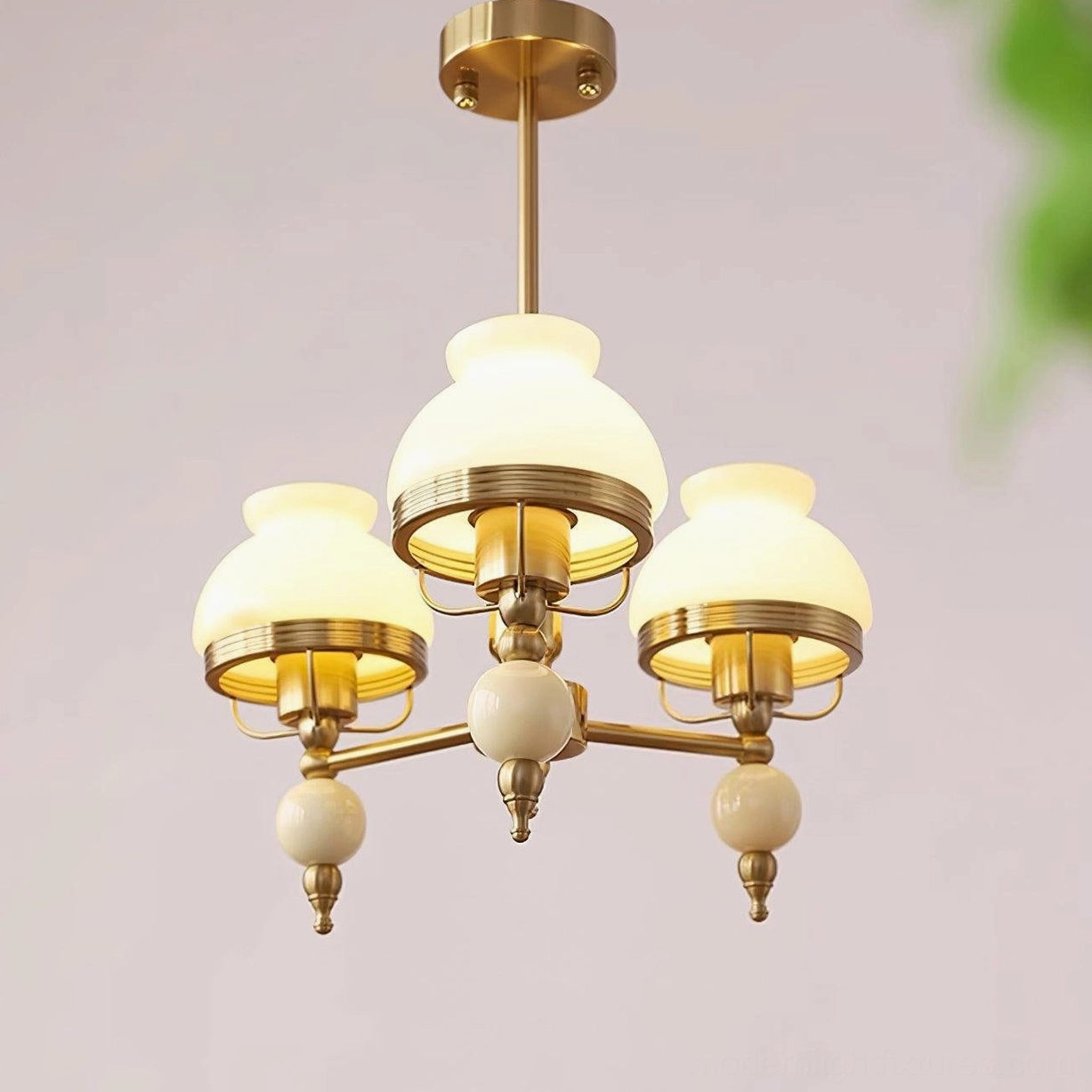 3-head retro pendant light with brass arms and milky white glass shades in home interior