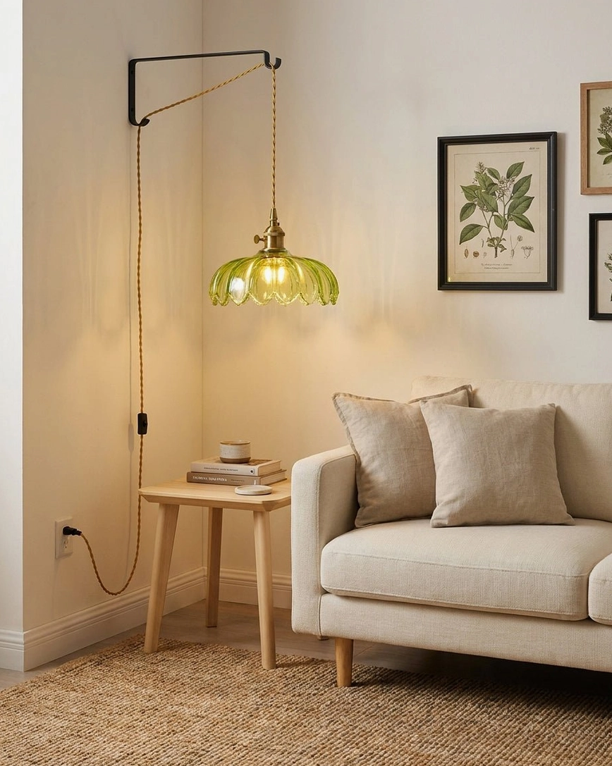 Wall-mounted fluted glass pendant light in retro living room corner with black bracket and cozy vintage decor