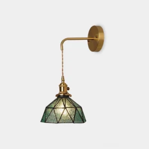 Retro pastoral stained glass wall sconce with geometric brass frame and green glass shade, studio product shot front view