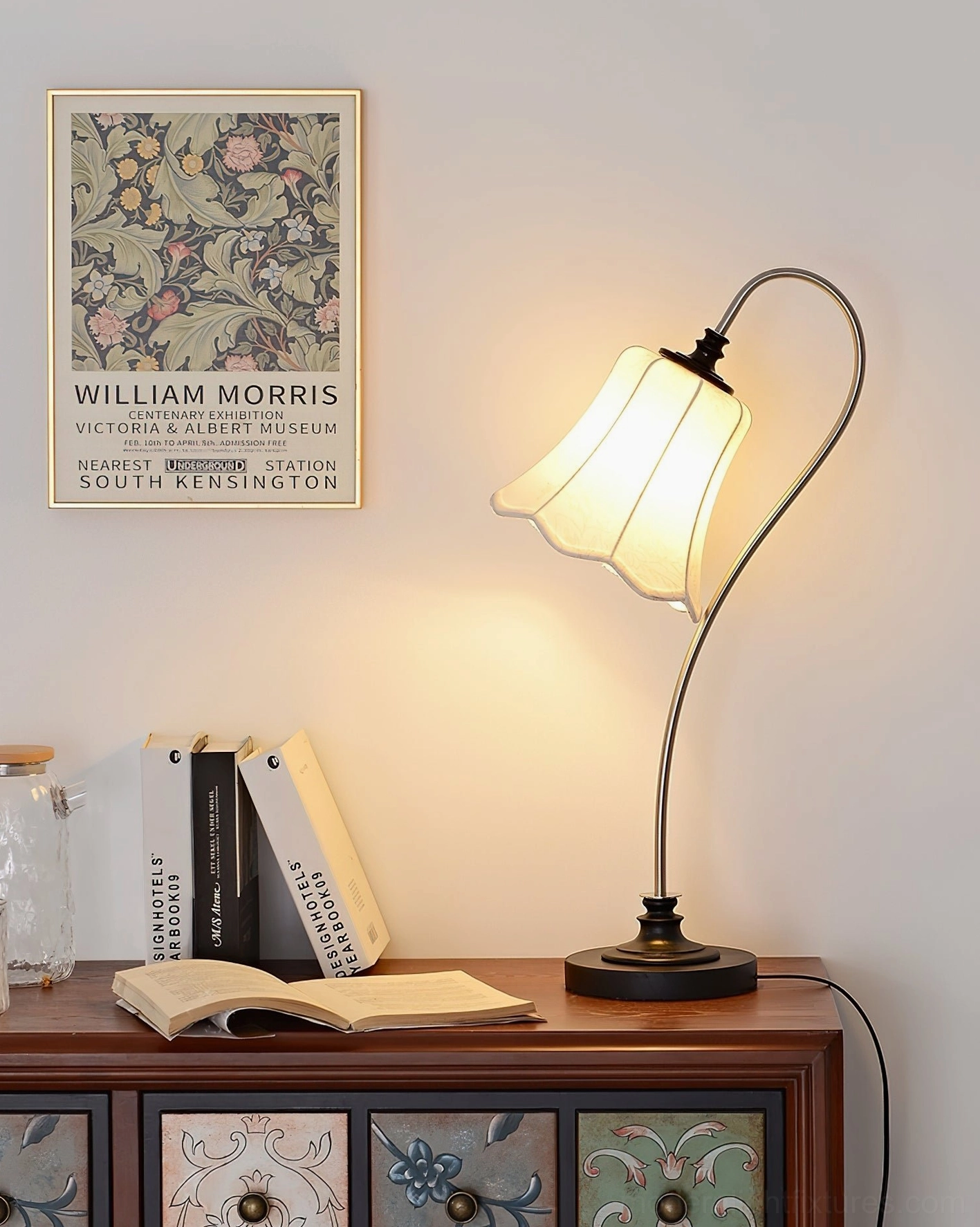 Retro table lamp with black metal base and lit lace fabric shade in living room setting