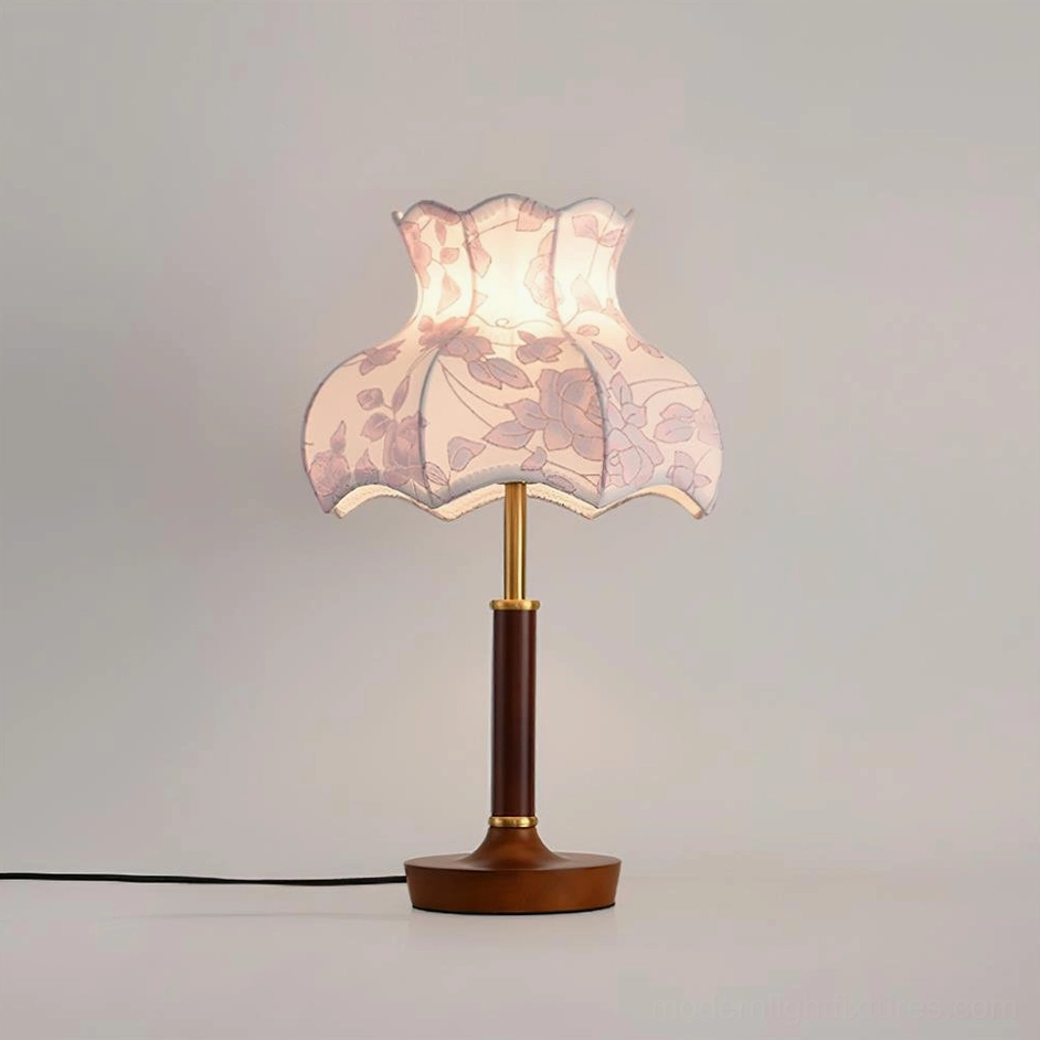 Retro table lamp with pink leaf printed scalloped shade and solid wood base, side profile view