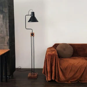 Industrial retro floor lamp three quarter view living room brown sofa ambient lighting