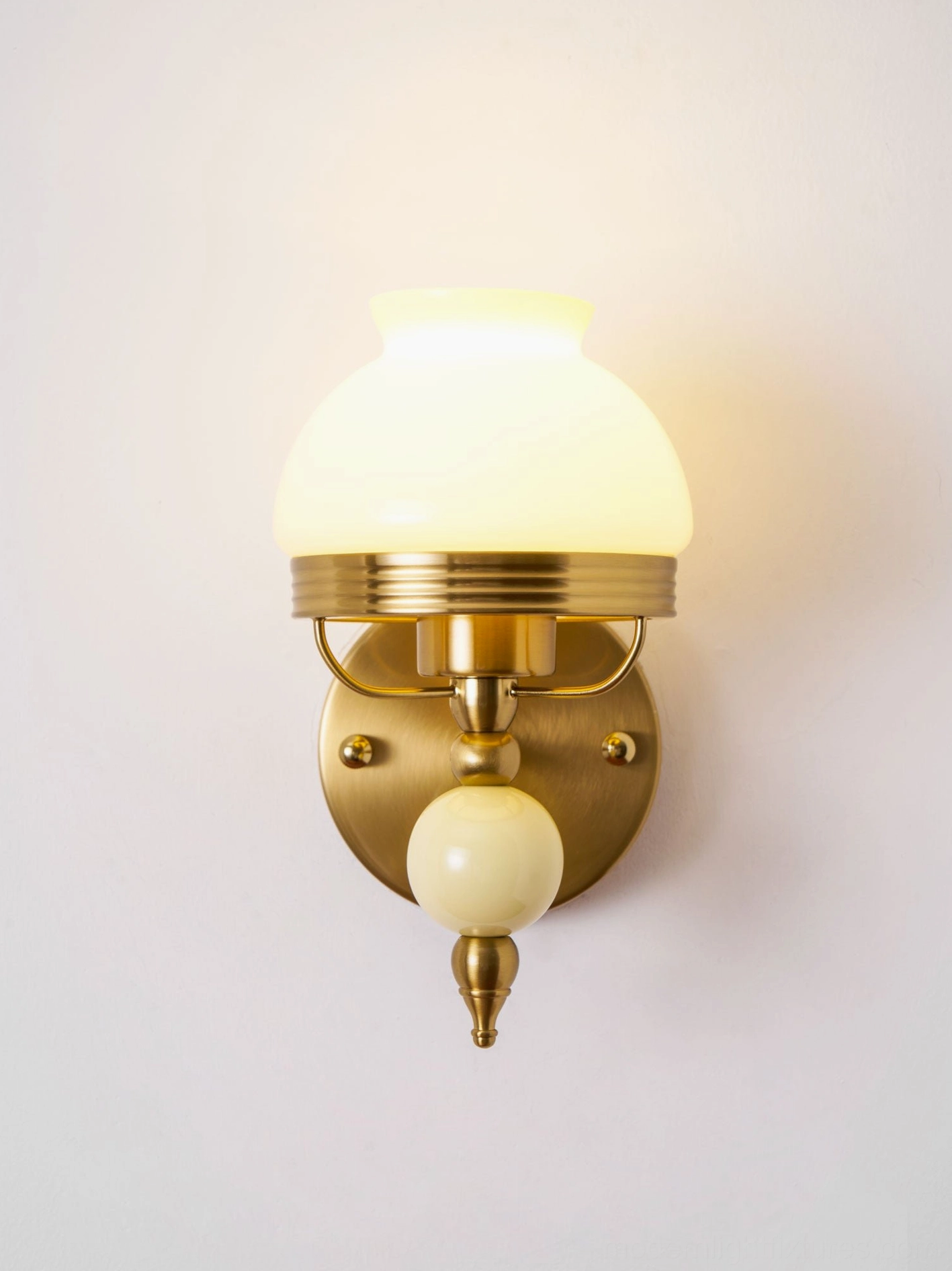 Retro wall sconce with detailed frosted glass floral pattern and vintage brass finish
