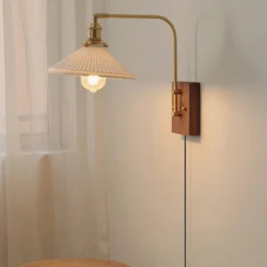 Retro plug-in wall sconce side profile showing brass arm and walnut wooden base mounted on neutral wall