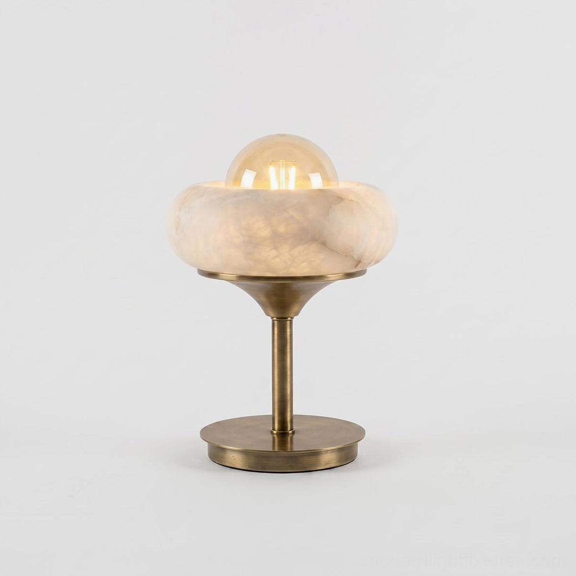 Retrovia alabaster table lamp on home office desk providing warm ambient study lighting, compact design fitting workspace without visual clutter