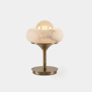 Retrovia alabaster table lamp with brass stem and weighted disc base, featuring exposed glass globe bulb seated in natural stone bowl, studio front view