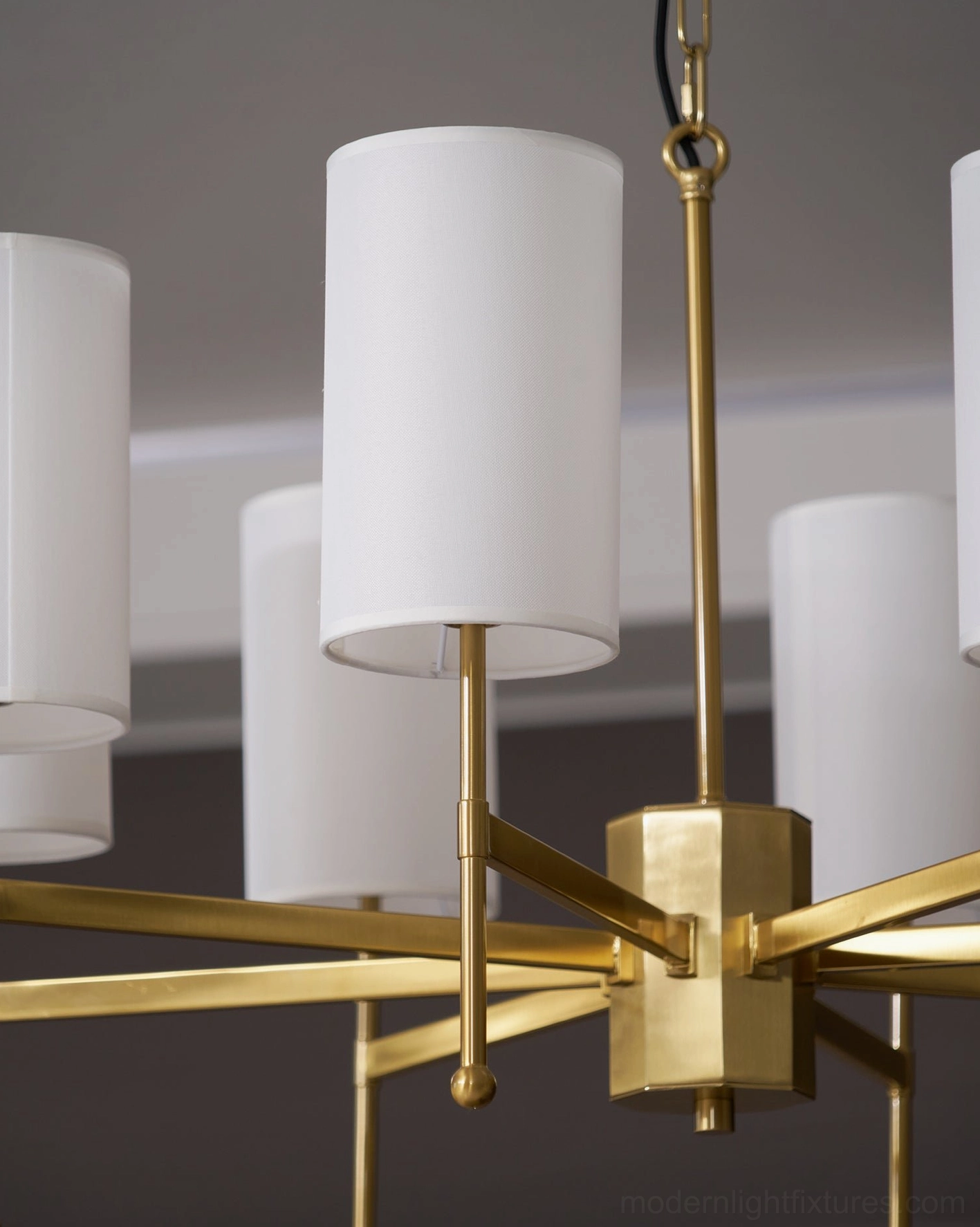 Mid-century modern Rhodes chandelier detail shot - brass arms and white fabric shade construction