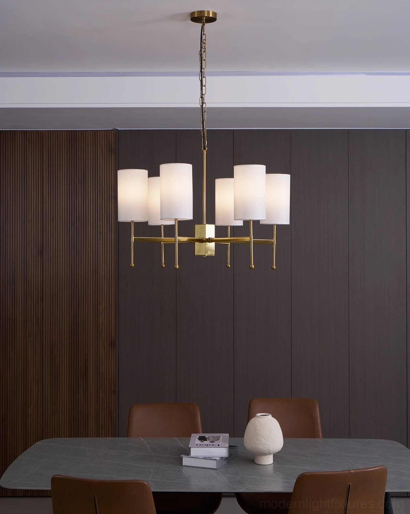 Rhodes chandelier showing geometric precision of arms and white cylindrical shade arrangement - geometric detail