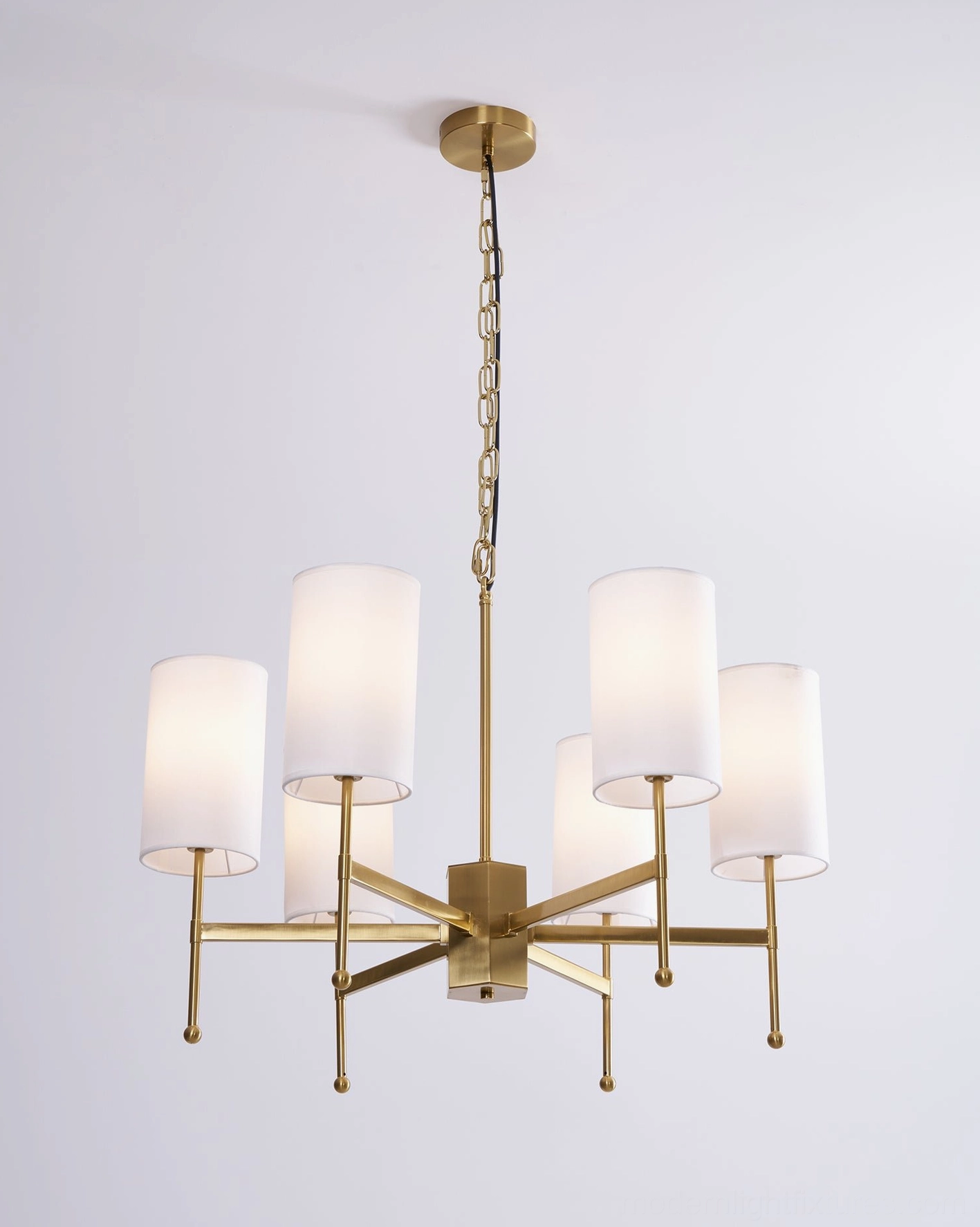 Rhodes brass and white chandelier hanging detail with adjustable chain and central fixture components