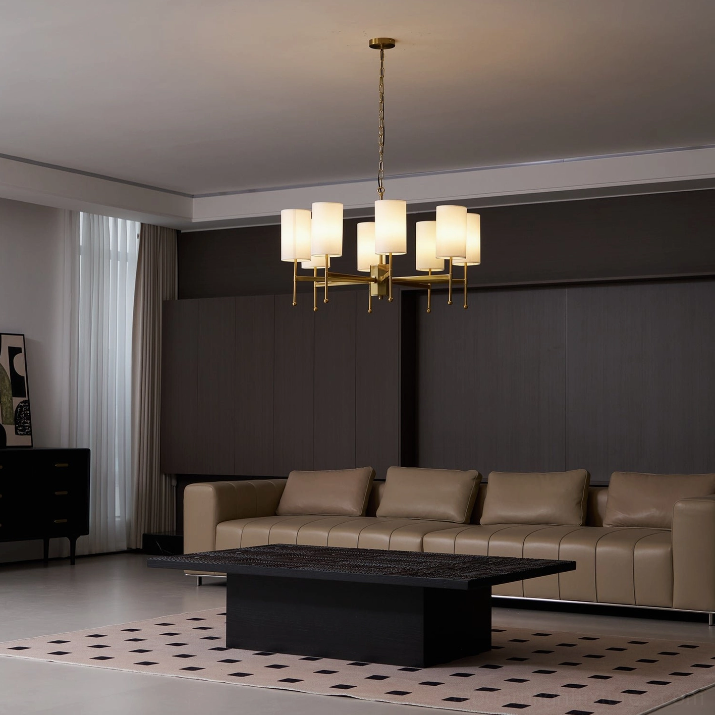 Rhodes brass chandelier with white shades in contemporary living room with leather sofa and area rug - side view