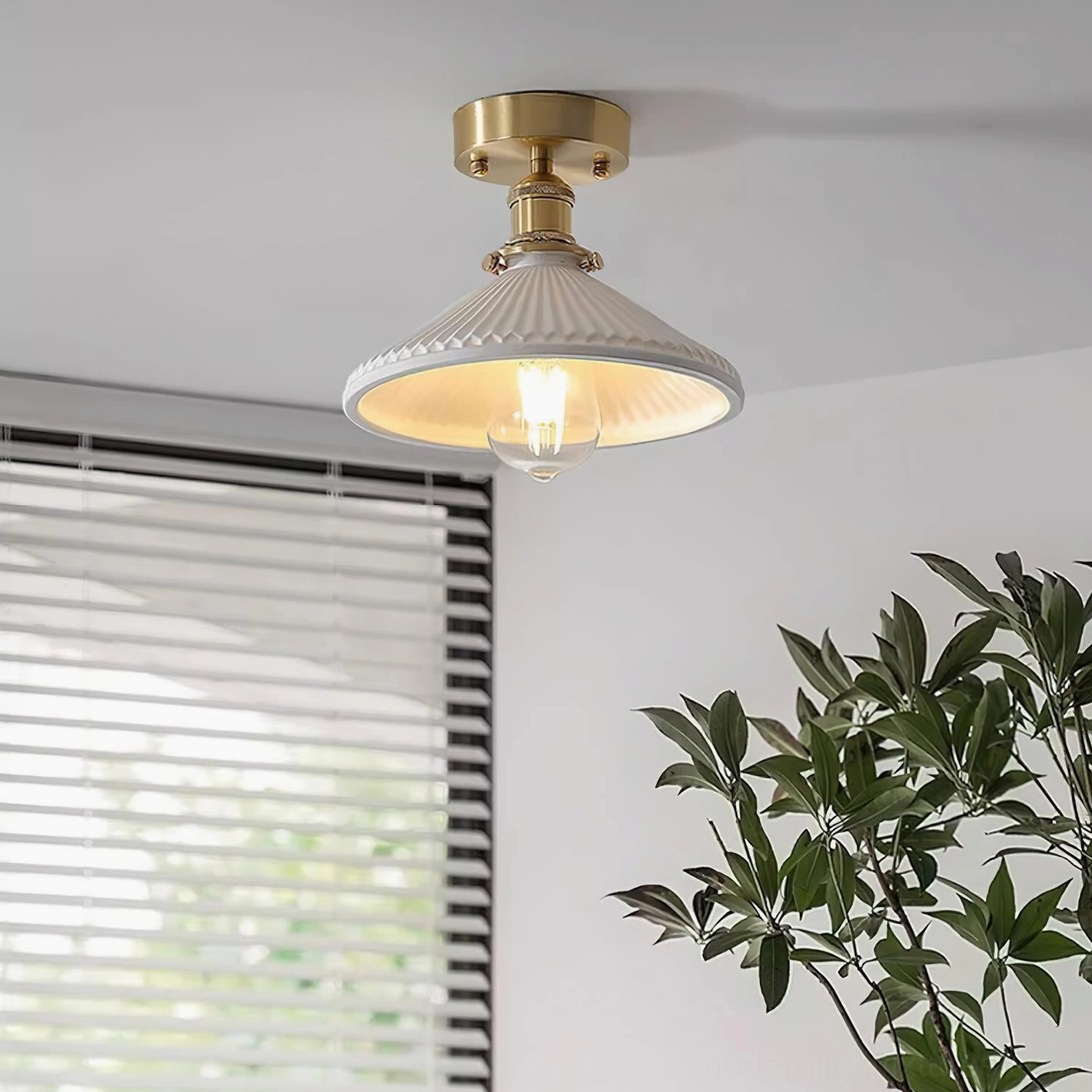 Rialto ceiling light mounted in home corner view featuring brass hardware and fluted white ceramic shade with warm lighting