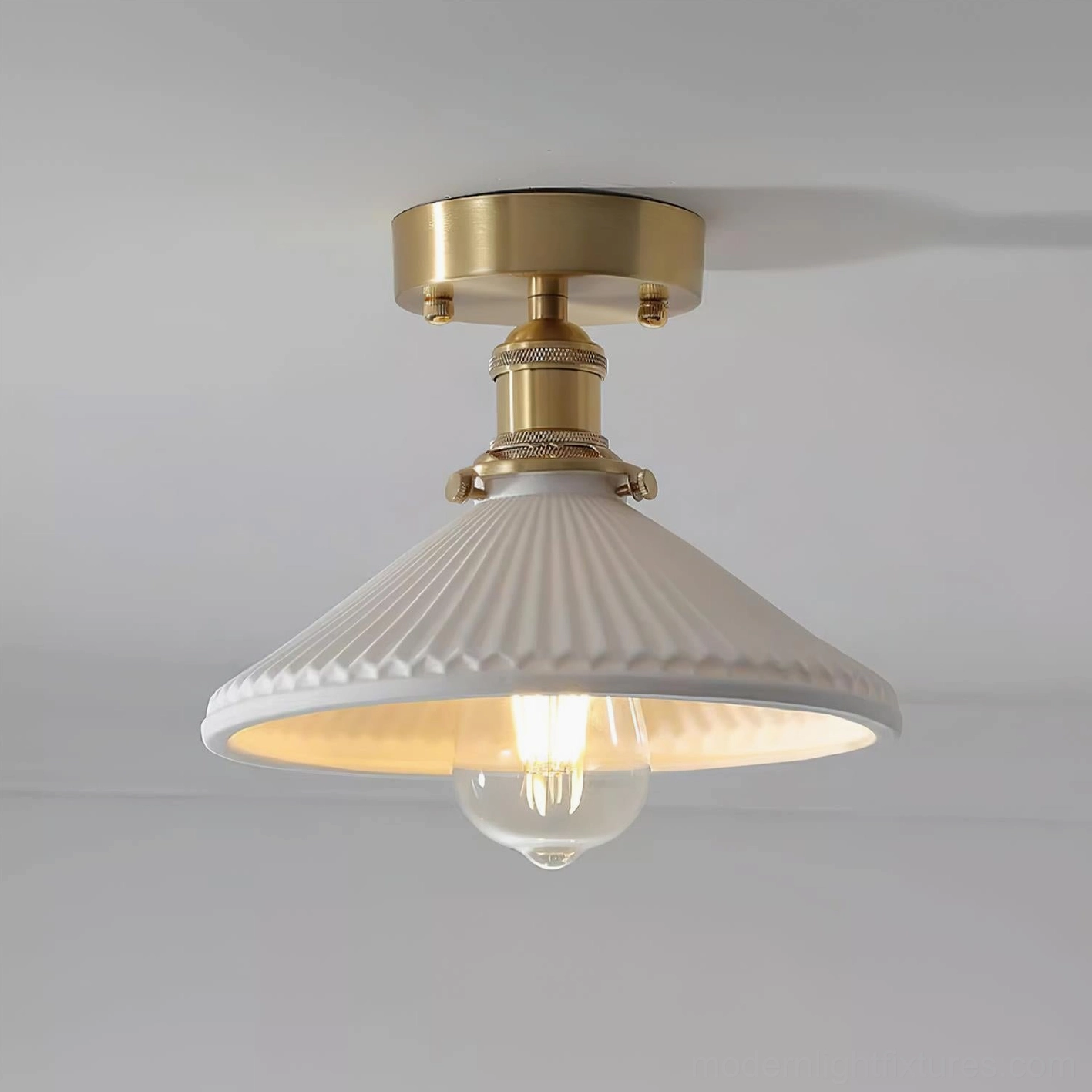 Rialto ceiling light close-up front view with brushed gold base and wide ribbed white ceramic shade
