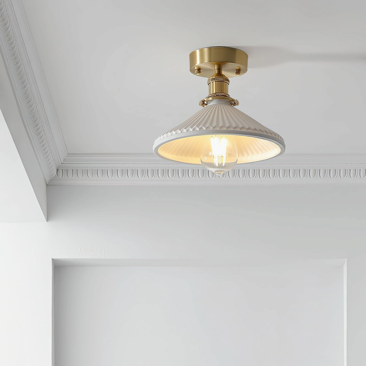 Rialto semi-flush light fixture detail shot showing brass base and fluted white ceramic shade against crown molding