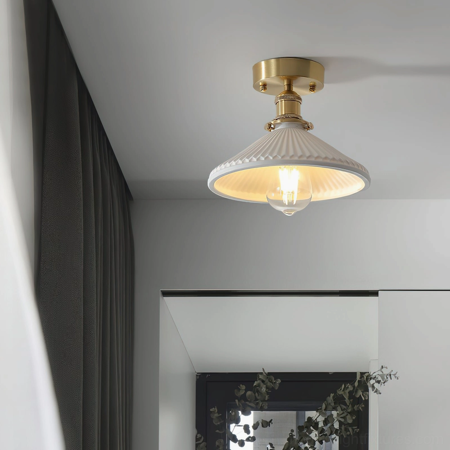 Rialto ceiling light mounted indoors showing brass fixtures and white ribbed shade with Edison-style exposed bulb glow