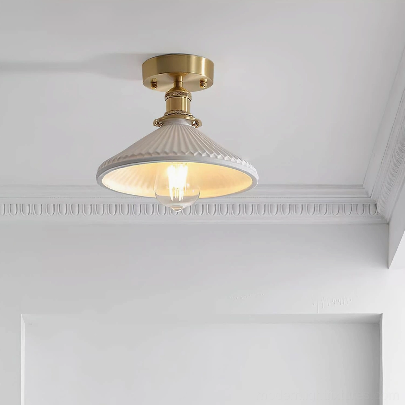 Rialto ceiling light installed overhead showing gold-toned brass hardware and ribbed white shade in decorated interior space