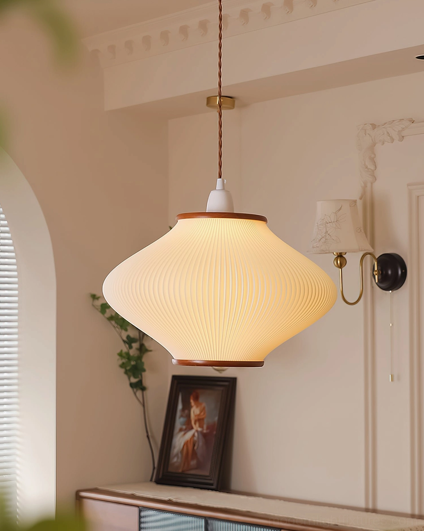 Minimalist pendant light with warm diffused glow over console table, side wall view in neutral vintage interior
