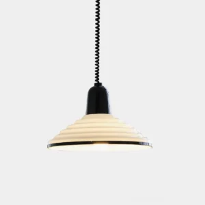 Modern ribbed metal pendant light with cream finish and black top, hanging against plain white background with warm internal lighting
