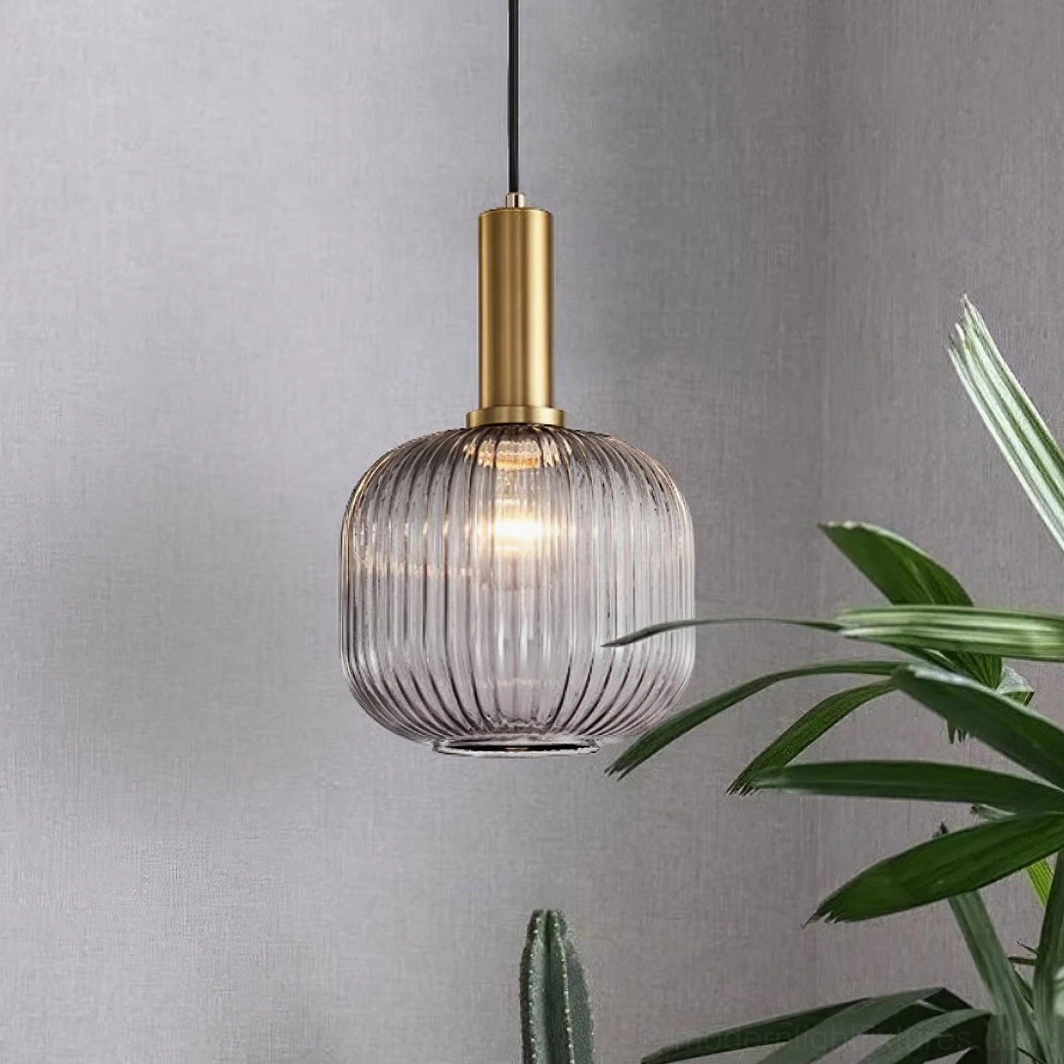 Brass canopy and mounting hardware detail of modern ribbed glass pendant lamp installation assembly