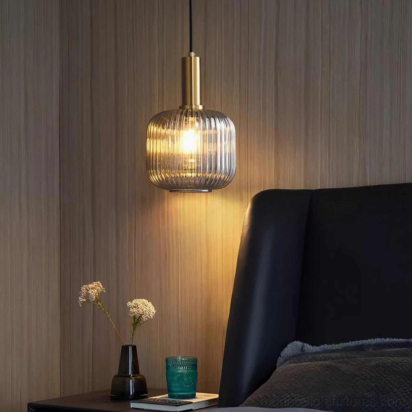 Ribbed glass pendant lamp dimmed to low setting showing warm atmospheric glow and evening ambiance effect