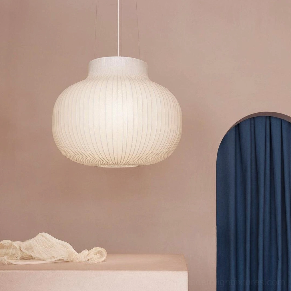 White ribbed pendant light installed in contemporary living room with neutral color palette