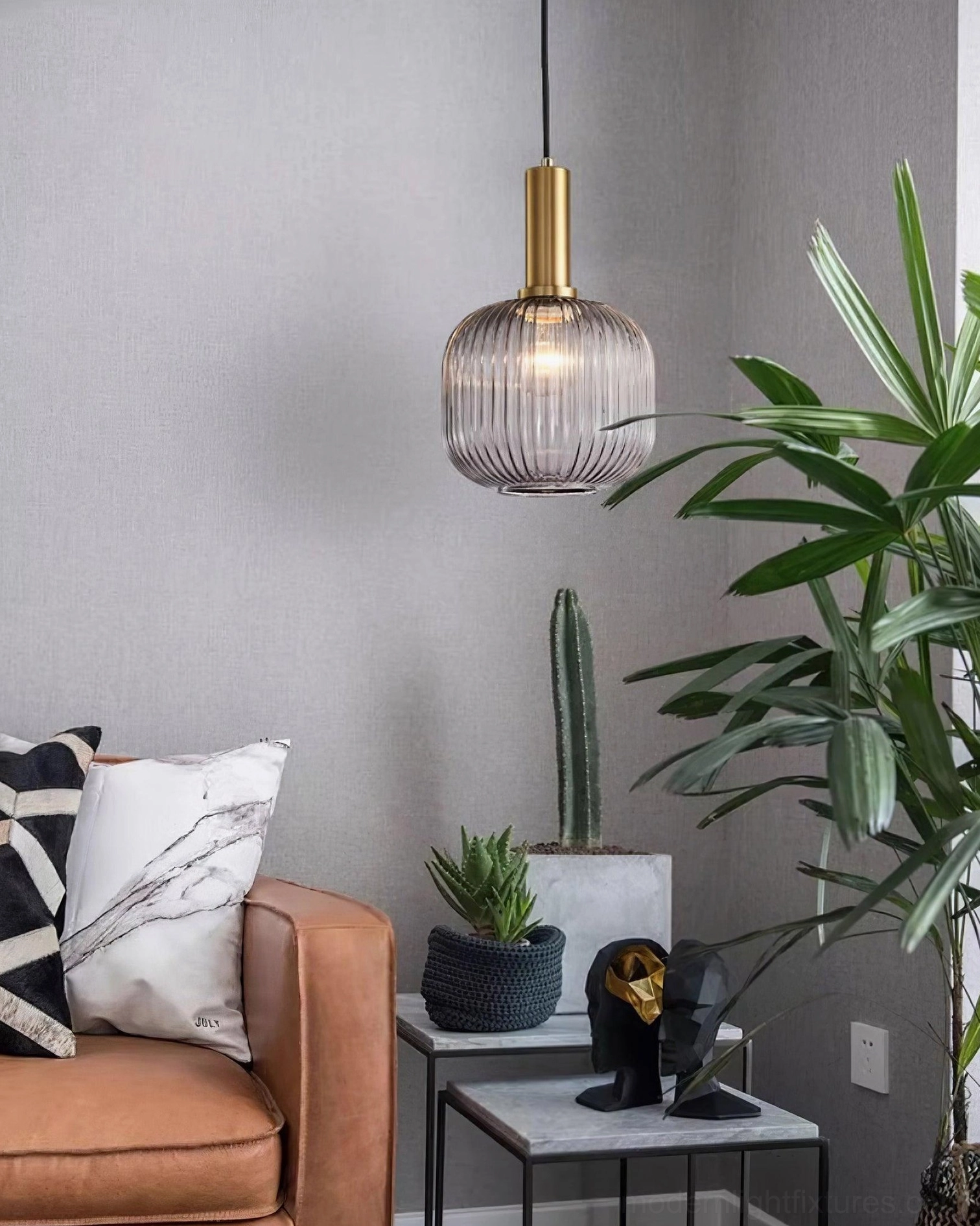 Ribbed glass pendant lamps with table lamp layered lighting showing mixed light sources for natural illumination