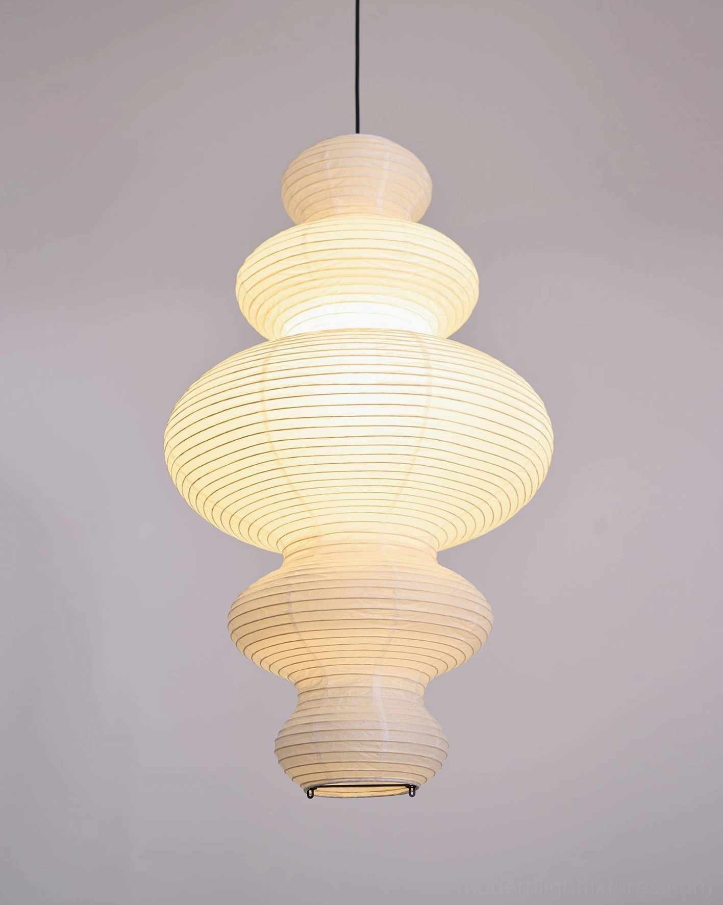 Sculptural white rice paper pendant light in elegant formal dining room conversation setting