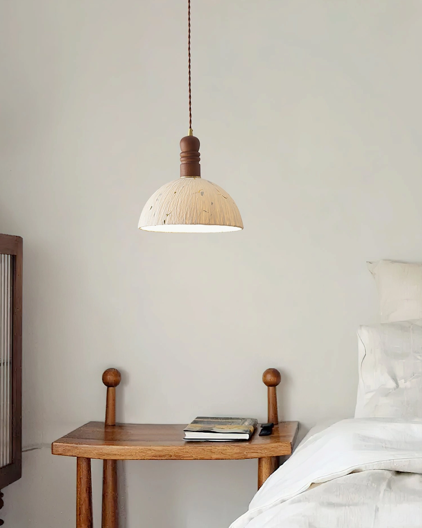 Close-up detail of handcrafted rice paper dome shade with embedded organic leaf pattern texture