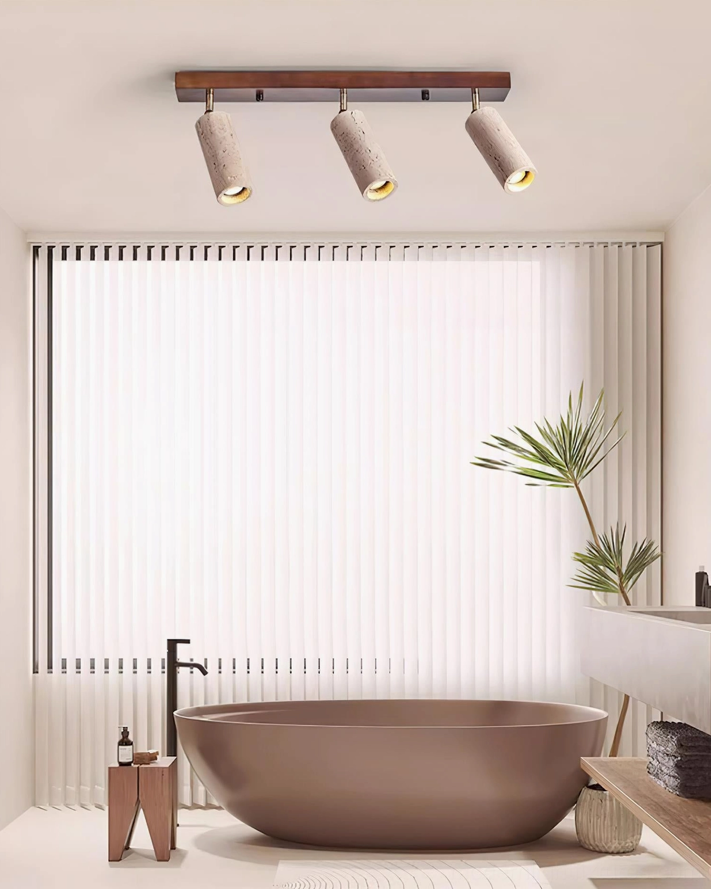 Luxury bathroom with Ricerca 3-head track ceiling light above freestanding bathtub, dark wood frame and wabi-sabi interior decor