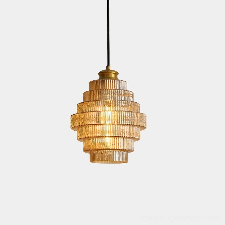 Ridged glass pendant light with amber tiered glass shade and brass canopy, studio front view