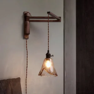 Rigale adjustable wall sconce three-quarter view in living room corner with walnut wood finish