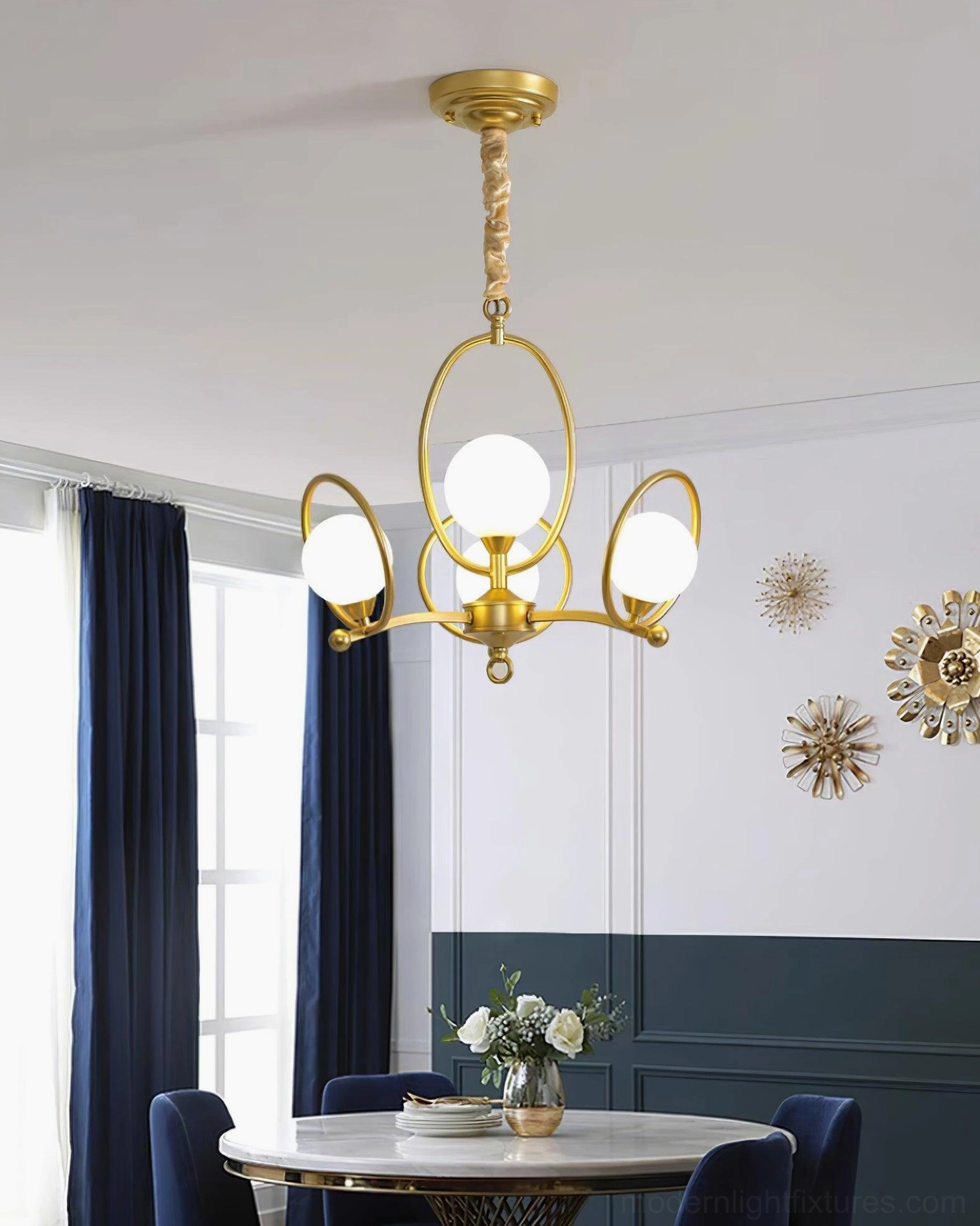 Riley glass chandelier overhead view in contemporary dining space with symmetrical metal arms and spherical glass shades