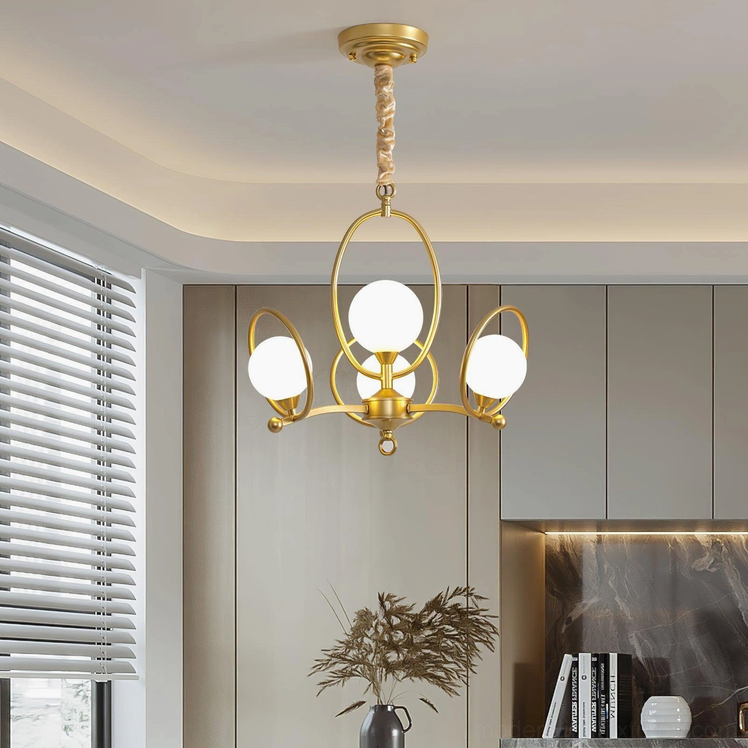 Riley 4-head chandelier in modern kitchen dining area with twisted gold hanging cord and frosted glass bulbs