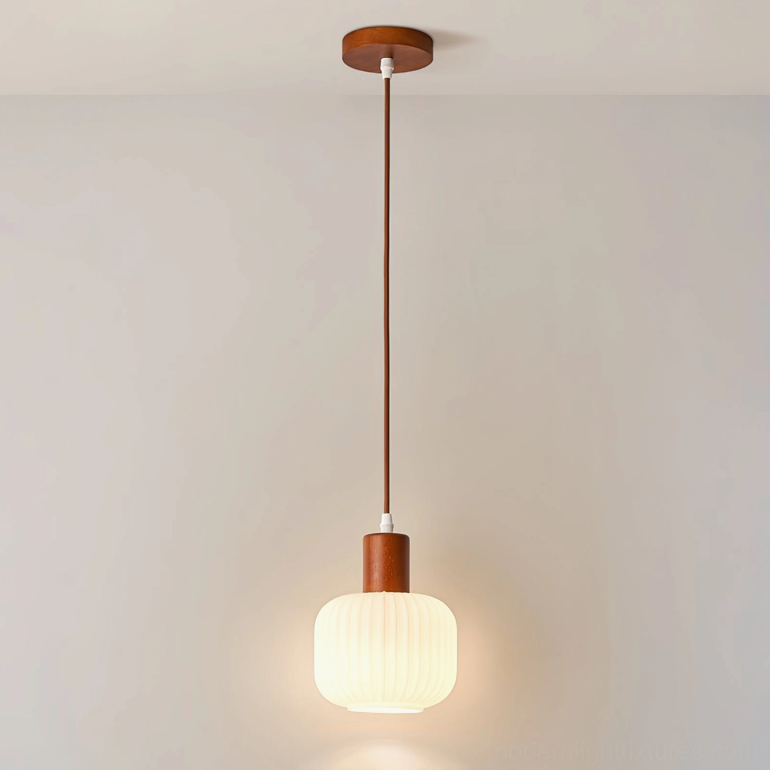 Contemporary walnut wood pendant light with frosted shade, architectural product photography